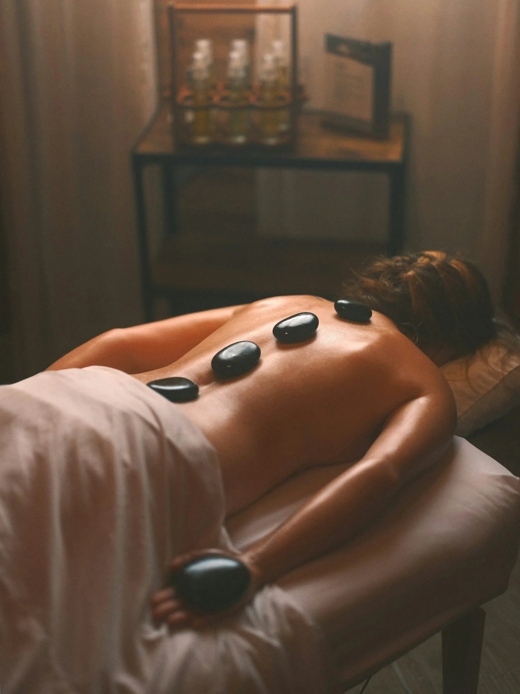 Hot stones placed along a back during a treatment